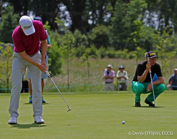Michael Hoey putting on the 4th green watched byGermany's Marcel Siem