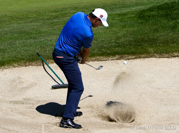 Padraig Harrington practices a shot out of the bunker on practice day for the Irish Open