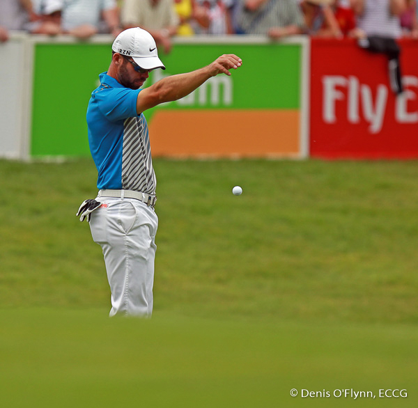 Paul Casey drops the ball onto the green after his shot went into the water on the final day of the Irish Open